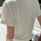 back view of model wearing a white linen blend relaxed fit t-shirt