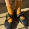 model wearing mustard breezy sneaker socks with buckle mary janes