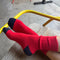 model wearing bright red socks with navy toes and heel