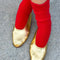 model wearing bright red socks with navy toes and heel with gold flats