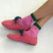 model wearing pink crew socks with green trim and red embroidered heart