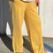 side view of model wearing french terry deep yellow balloon pants with side pockets