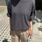 model wearing dark slate oversized tee with extended sleeves