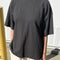 model wearing dark slate oversized tee with extended sleeves