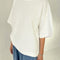 side view of model wearing white oversized tee with oversized sleeves