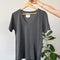 vintage washed black v-neck relaxed tee on a wooden hanger