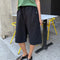 model wearing black cotton relaxed fit bermuda shorts