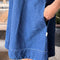 up close of model wearing blue denim mini dress