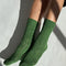 model wearing palm green pointelle socks