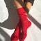 model wearing poppy red pointelle socks