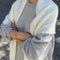 model wearing naturel pointelle square shawl with scalloped edges