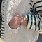 up close of model wearing natural chunky knit open front vest with patch pockets