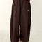 model wearing dark brown oversized parachute pants