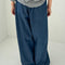 back view of model wearing denim blue parachute cotton pants