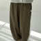 model wearing olive green parachute cotton pants