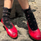 model wearing black ruffle socks with pink dainty flower print