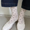 model wearing oatmeal socks with dainty all-over black dots