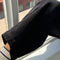 up close of model wearing black corduroy arc pants