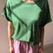 model wearing avocado green relaxed fit tee