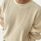 up close of model wearing cream colored waffle sweatshirt with slight balloon sleeves