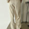 back view of model wearing cream waffle knit pants with elastic waist and side pockets