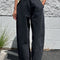 model wearing washed black arc pants with elastic waist, pockets, and barrel legs