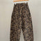 brown leopard print arc pants on a hanger