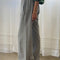 side view of model wearing heather grey wide leg pants with side inlets