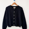 black cotton cardigan on a hanger
