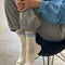 model wearing cream high crew socks with triple light blue stripes and embroidered red heart