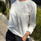 model wearing relaxed fit white long sleeve top with slight distressing around the collar