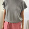 model wearing heather grey tee with slight cap sleeves, relaxed fit, and banded bottom