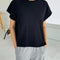model wearing black relaxed tee with muscle tee sleeves and side vents at the hem