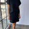 model wearing black relaxed tee with muscle tee sleeves and side vents at the hem