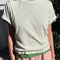 model wearing off white relaxed fit tee with a slight crop with a green tee underneath