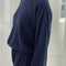 side view of model wearing navy pointelle sweatshirt with banded bottom