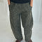 model wearing greenish leopard print arc pants with side pockets and side leg panels