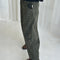 side view of model wearing greenish leopard print arc pants with side pockets and side leg panels