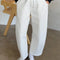 model wearing white relaxed fit pull on pants with side pockets