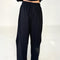 back view of model wearing black cotton wide leg pants with side inlets