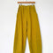 green olive corduroy arc pants with side panels and pockets on a hanger