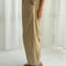 side view of model wearing khaki corduroy arc pants with side panels and pockets