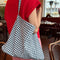 model carrying navy and white gingham rectangular bag