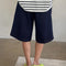 back view of model wearing dark blue bermuda shorts with side pockets
