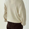 back view of model wearing cream pointelle long sleeve sweatshirt with banded wrists and waist