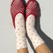 model wearing white socks with red polka dots