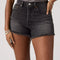 up close of model wearing washed black denim shorts with distressed hems