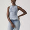 model wearing acid washed peplum tank top with several inlets