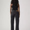 back view of model wearing low rise washed black wide leg jeans