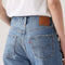 up close of back view of model wearing light denim 90's ankle jeans
